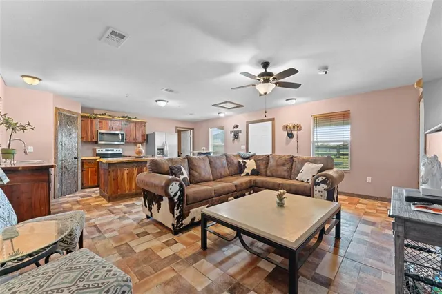a living room with furniture a chandelier and a table