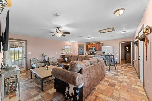 a living room with lots of furniture and a chandelier