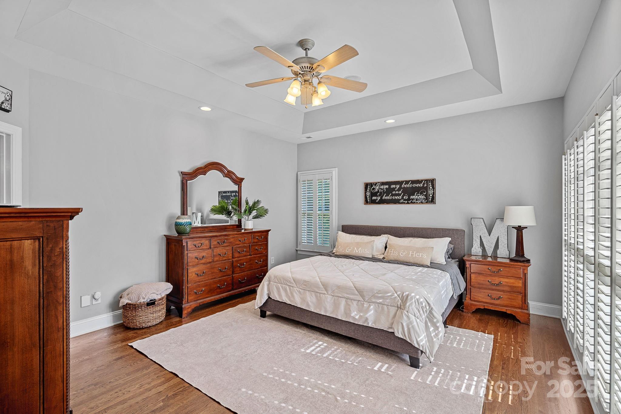 343 Gringley Hill Road Fort Mill, SC 29708 - Photo 15 of 45 a bedroom with a bed and a chandelier