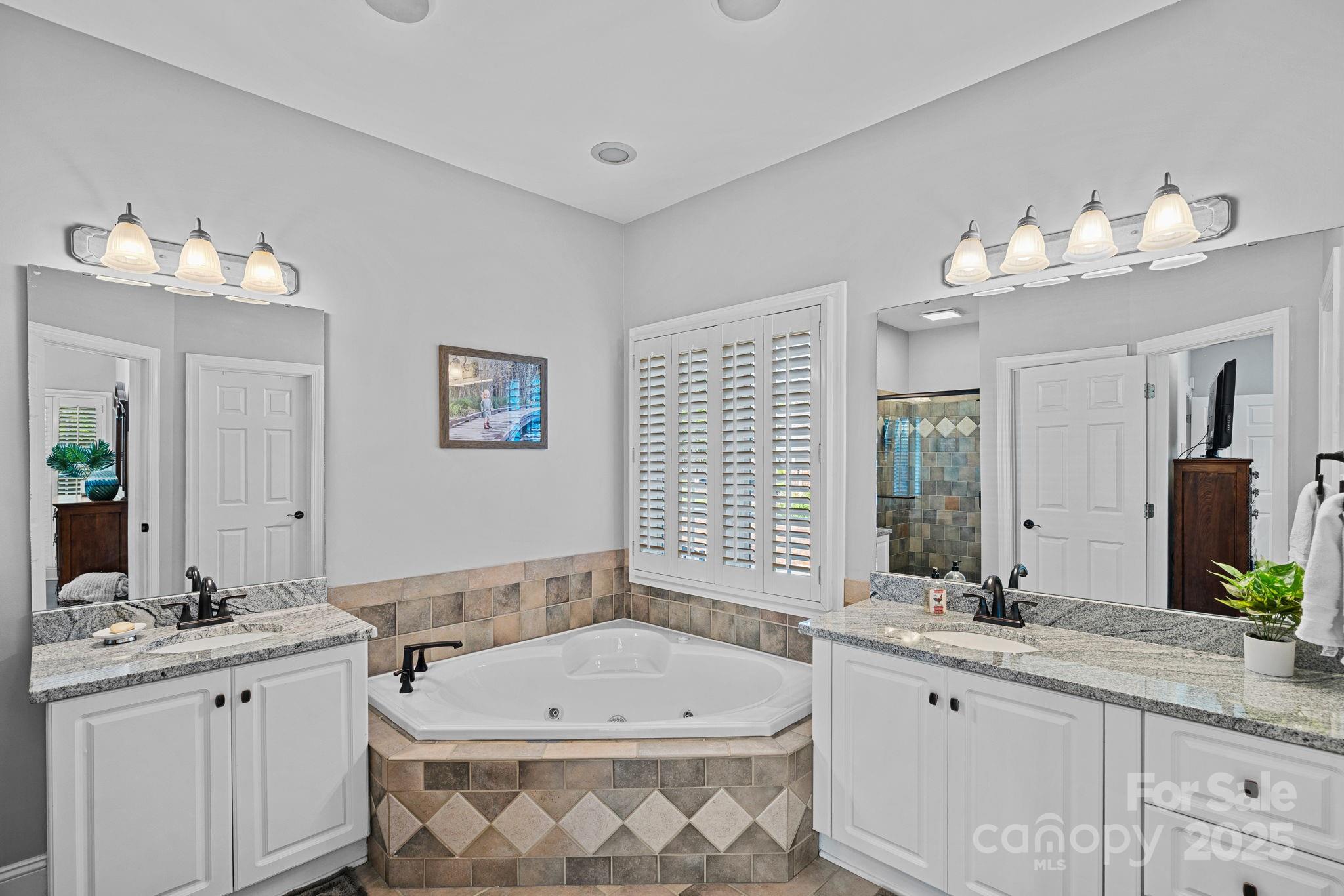 343 Gringley Hill Road Fort Mill, SC 29708 - Photo 16 of 45 a bathroom with a double vanity sink and a bathtub
