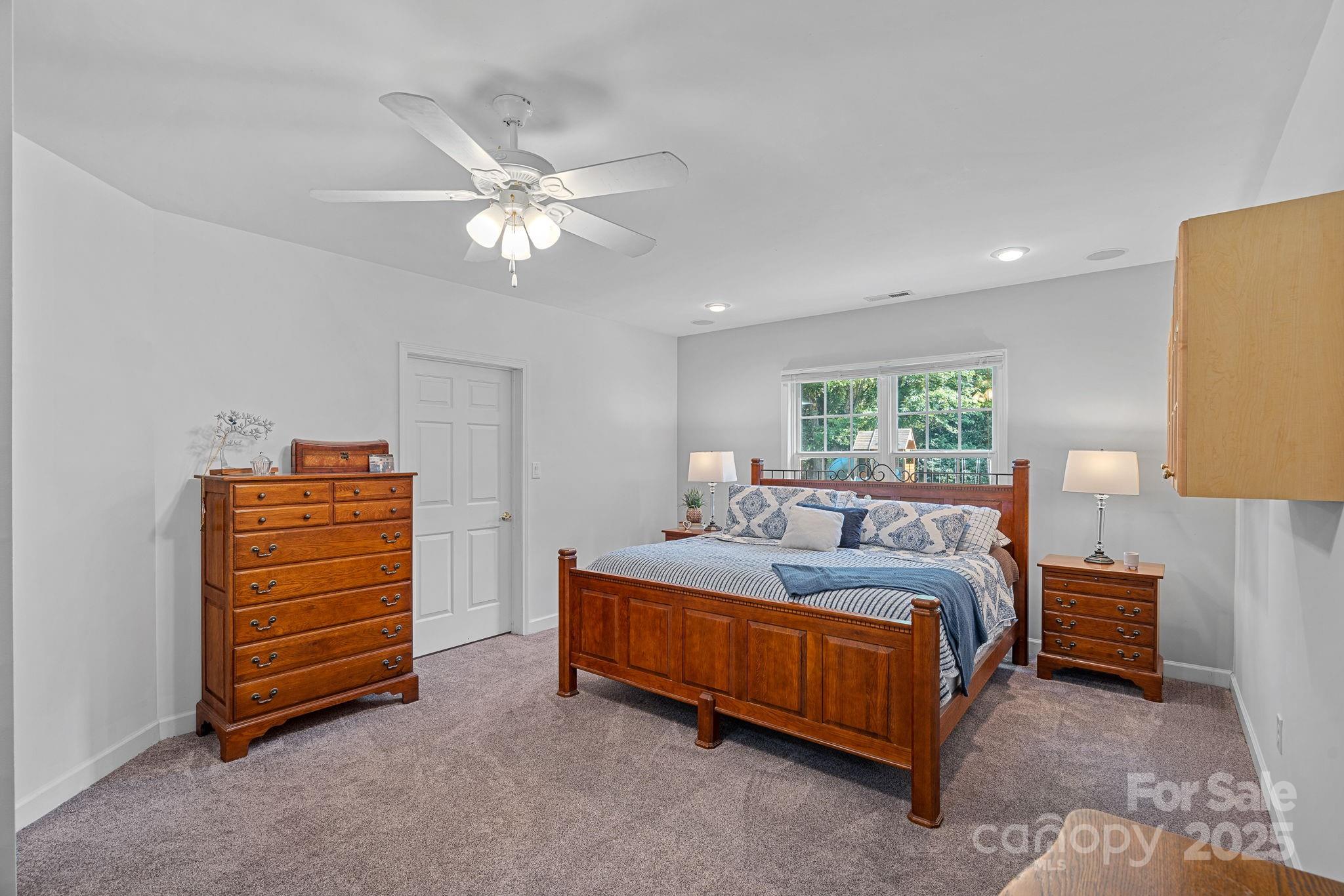 343 Gringley Hill Road Fort Mill, SC 29708 - Photo 23 of 45 a bedroom with a bed and a chandelier