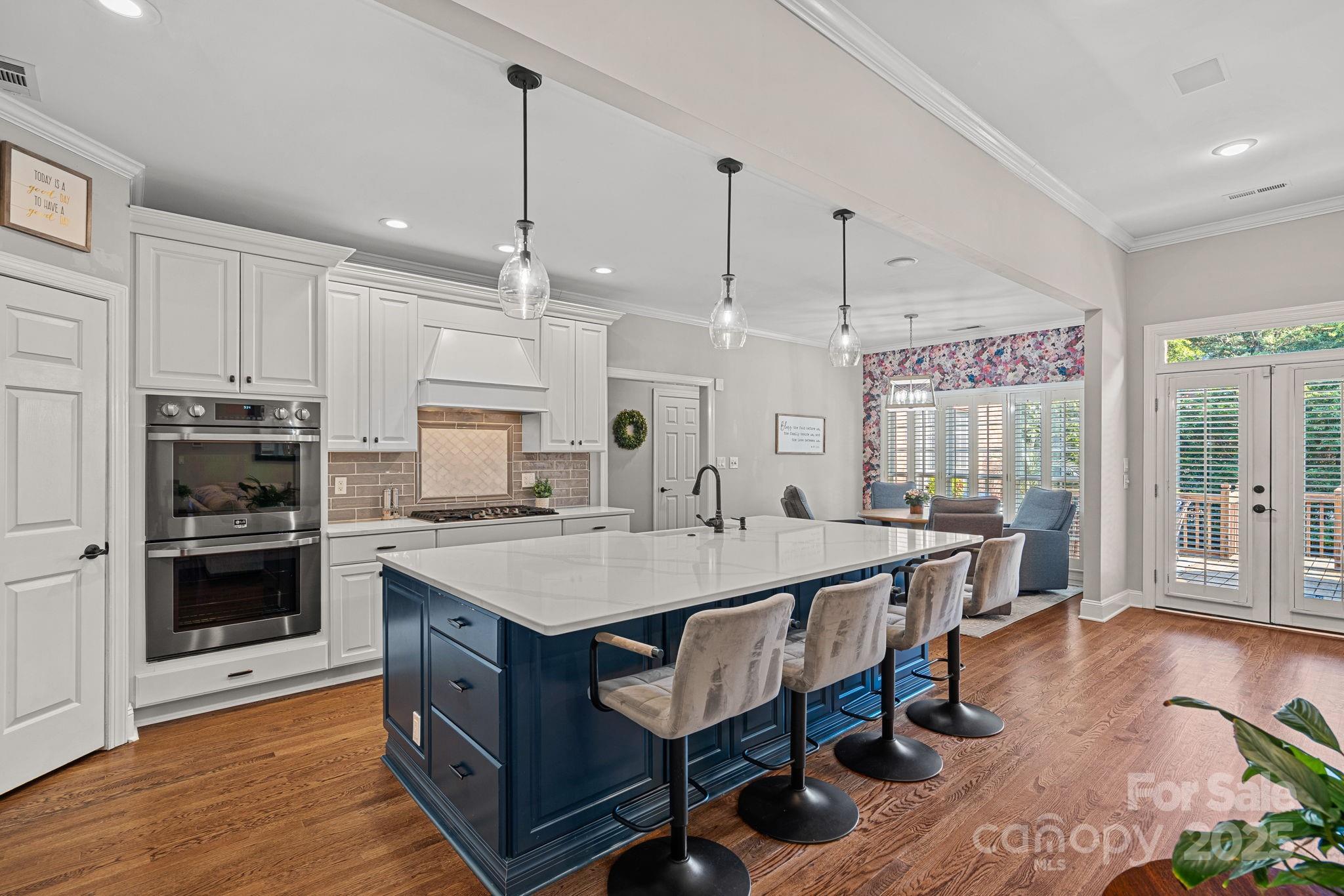 343 Gringley Hill Road Fort Mill, SC 29708 - Photo 5 of 45 a large kitchen with stainless steel appliances a stove center island wooden floor and cabinets