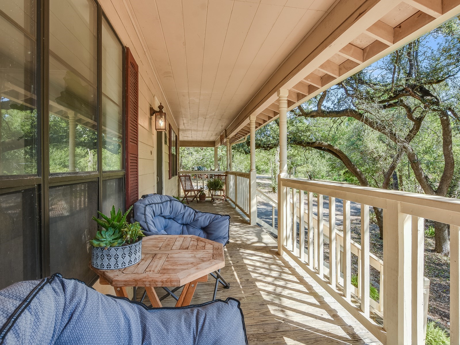 13404 Cedar Lime Road Leander, TX 78641 - Photo 23 of 28 A deep, shaded porch invites relaxation with ample space and leafy tree views.