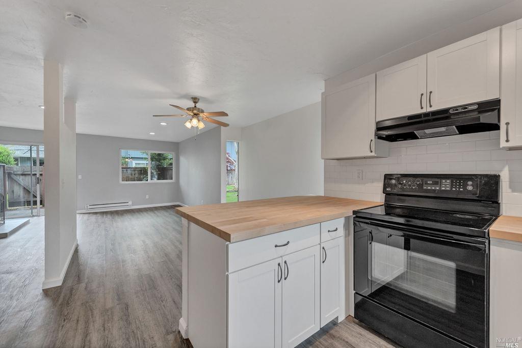 611 Racquet Club Circle Rohnert Park, CA 94928 - Photo 1 of 1 a kitchen with a stove and a wooden floor