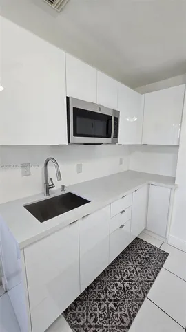 a kitchen with sink and cabinets
