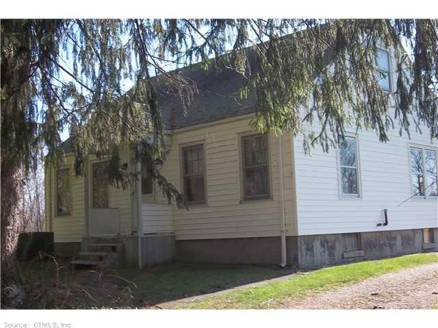 a side view of a house with a yard