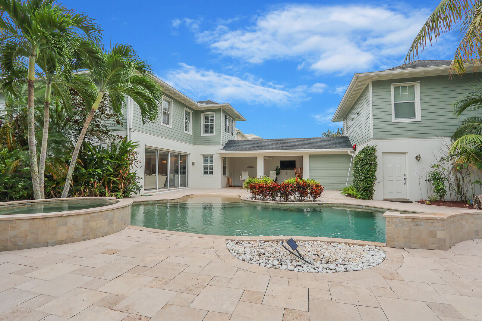 101 St Pierre Way Jupiter, FL 33458 - Photo 51 of 57 a front view of a house with swimming pool having outdoor seating