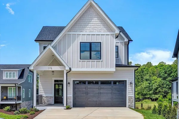 a front view of a house with a garage and balcony