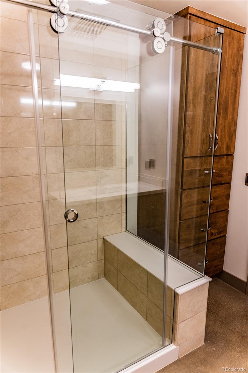475 West 12th Avenue, Unit 15G Denver, CO 80204 - Photo 11 of 15 a bathroom with a shower and a mirror