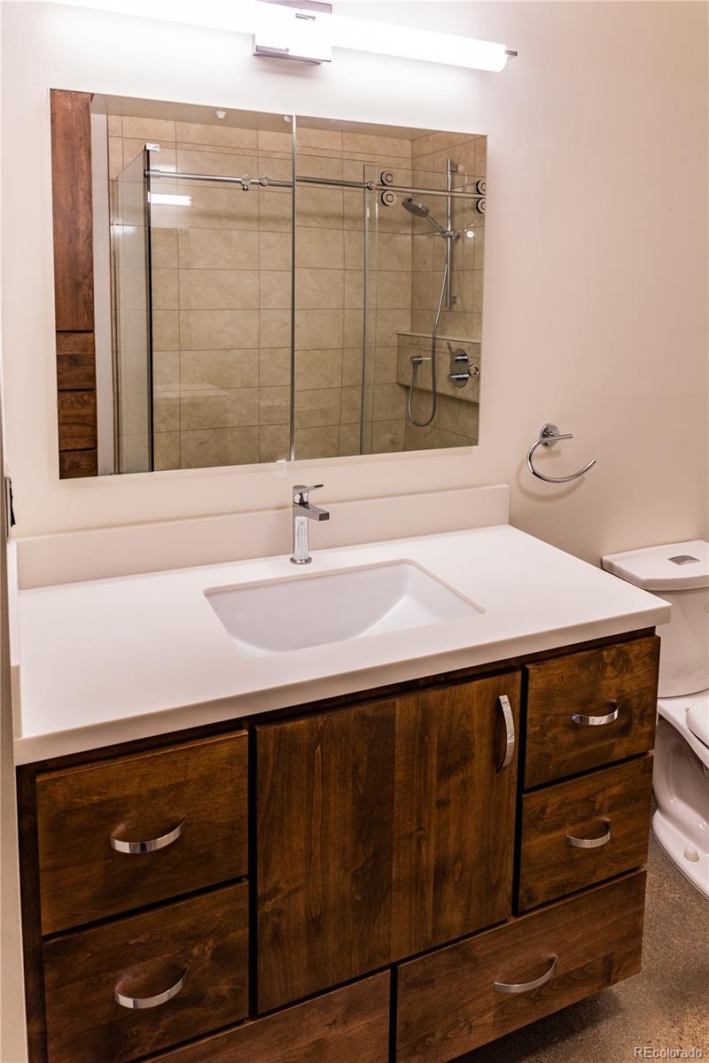 475 West 12th Avenue, Unit 15G Denver, CO 80204 - Photo 12 of 15 a bathroom with a sink and a mirror