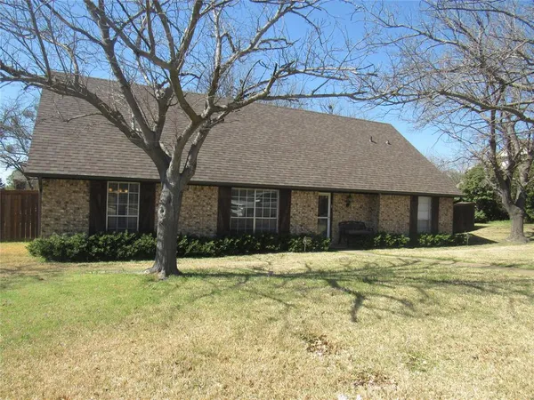 a house that has a tree in front of it