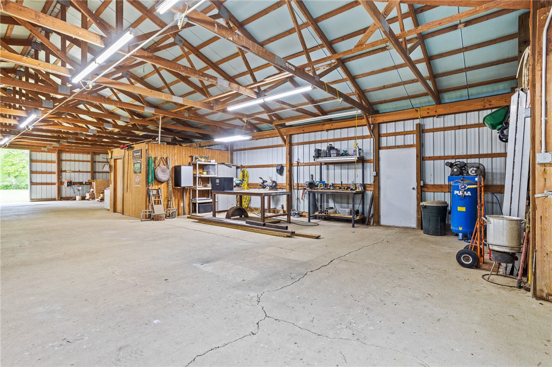 4222 Ramsey Road Springfield, OH 45502 - Photo 75 of 79 This spacious workshop features durable concrete flooring, exposed wood beams, and ample workspace for any project.