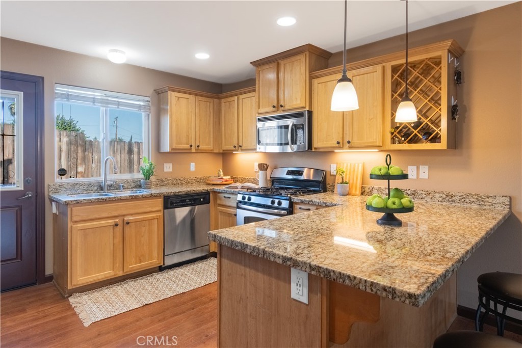 945 Creston Road Paso Robles, CA 93446 - Photo 6 of 13 a kitchen with stainless steel appliances granite countertop wooden cabinets a sink a stove a dining table and chairs