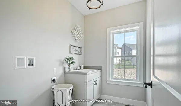 a bathroom with a toilet a sink and a window