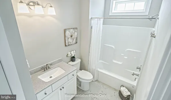 a bathroom with a granite countertop toilet a sink and a bathtub