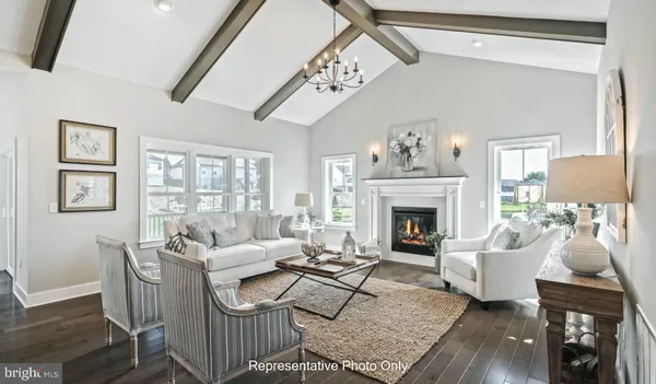 a living room with furniture a large window and a fireplace