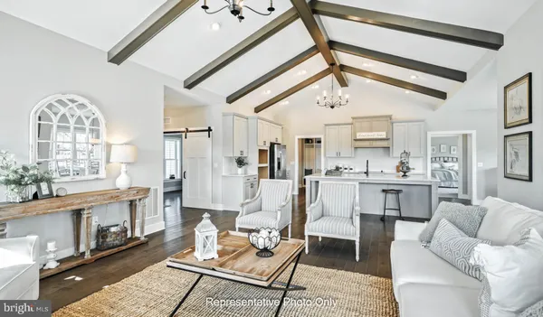 a living room with furniture a fireplace and a chandelier