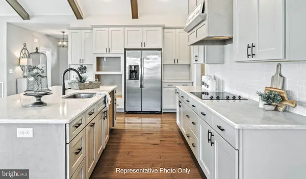 a kitchen with kitchen island a sink stove and refrigerator