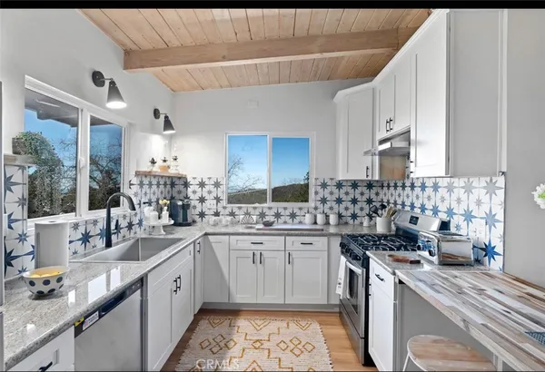 a kitchen with a sink stove and cabinets
