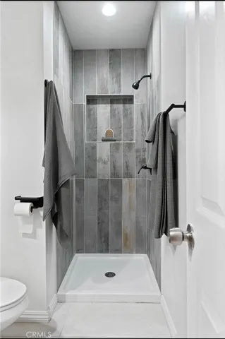 a bathroom with a shower and toilet