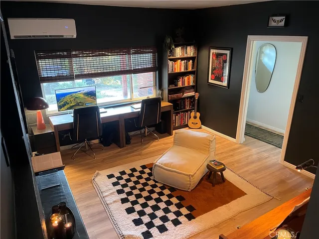 a bedroom with furniture window and wooden floor
