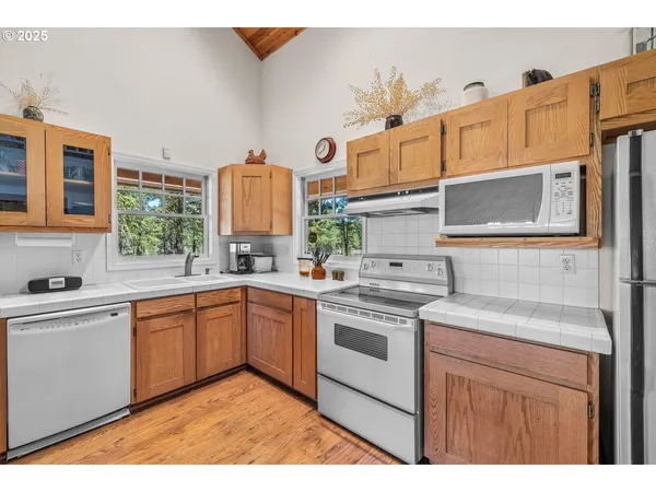 a kitchen with stainless steel appliances granite countertop a sink and cabinets