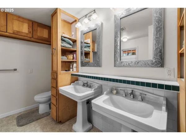 a bathroom with a sink toilet and mirror