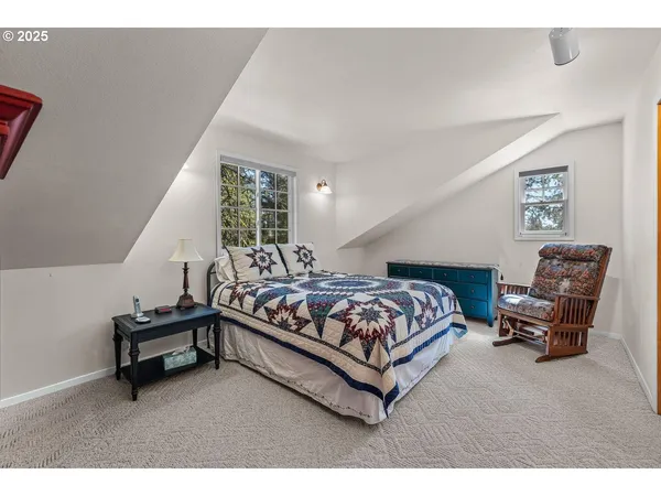 a bedroom with a bed and a chair