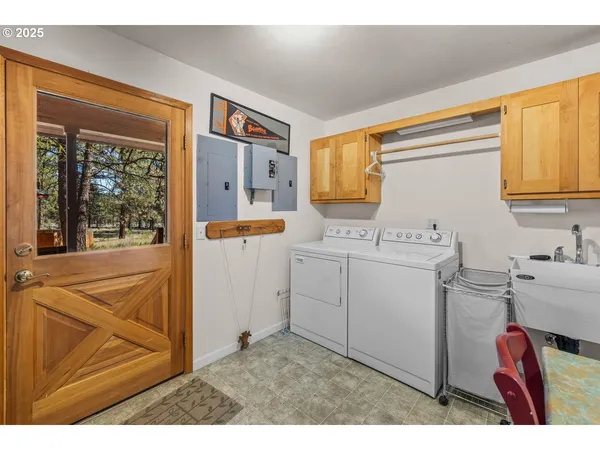 a utility room with sink dryer and washer