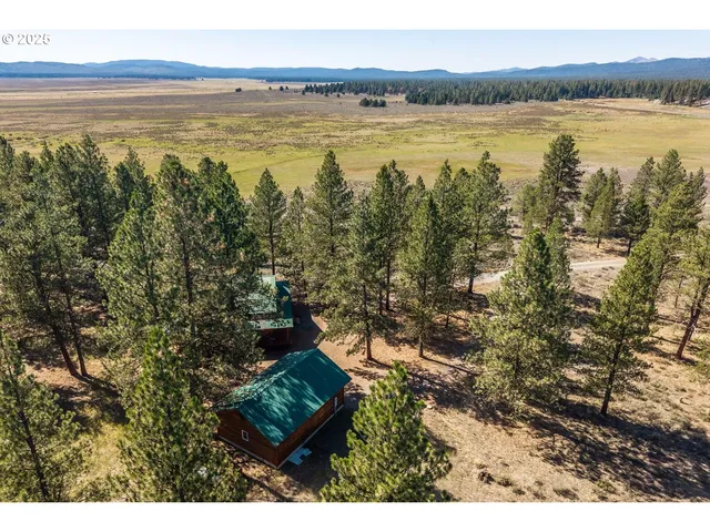 a view of a house with a yard covered in snow