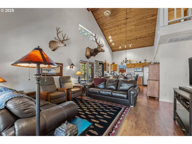 a living room with furniture a ceiling fan and a rug