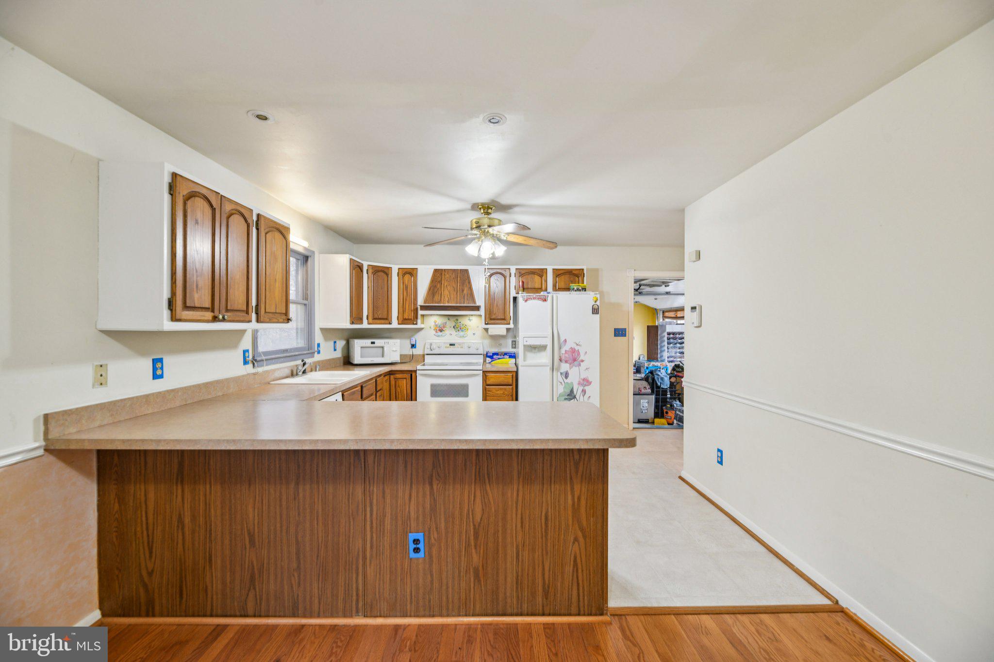 2650 Solomons Island Road Huntingtown, MD 20639 - Photo 14 of 44 a living room with kitchen island granite countertop furniture and a wooden floor