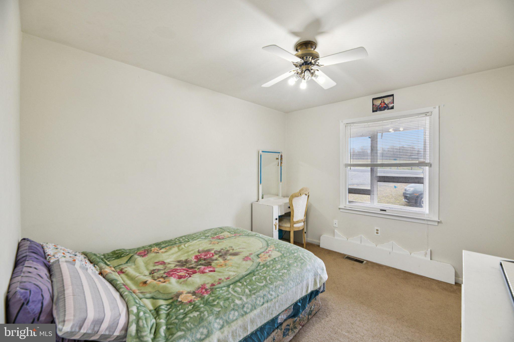 2650 Solomons Island Road Huntingtown, MD 20639 - Photo 18 of 44 a bedroom with a bed and a chandelier
