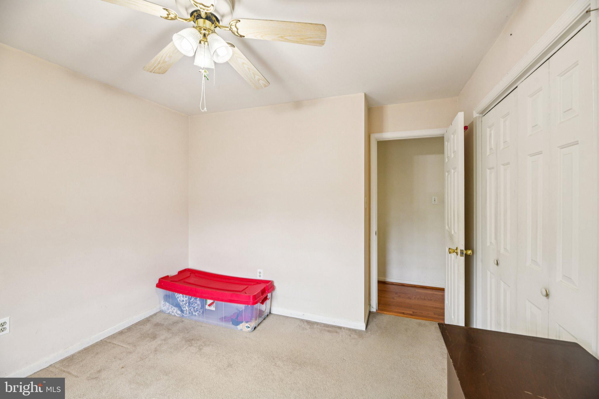 2650 Solomons Island Road Huntingtown, MD 20639 - Photo 21 of 44 an empty room with a chandelier fan and wooden floor