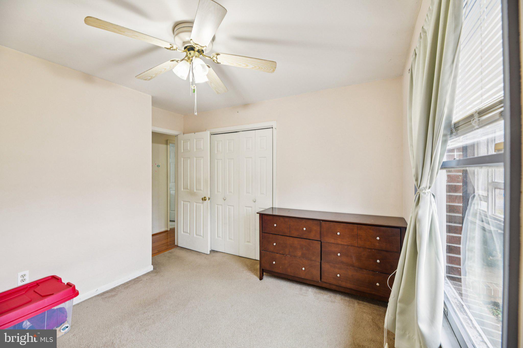 2650 Solomons Island Road Huntingtown, MD 20639 - Photo 22 of 44 a spacious bedroom with a bed and a chandelier