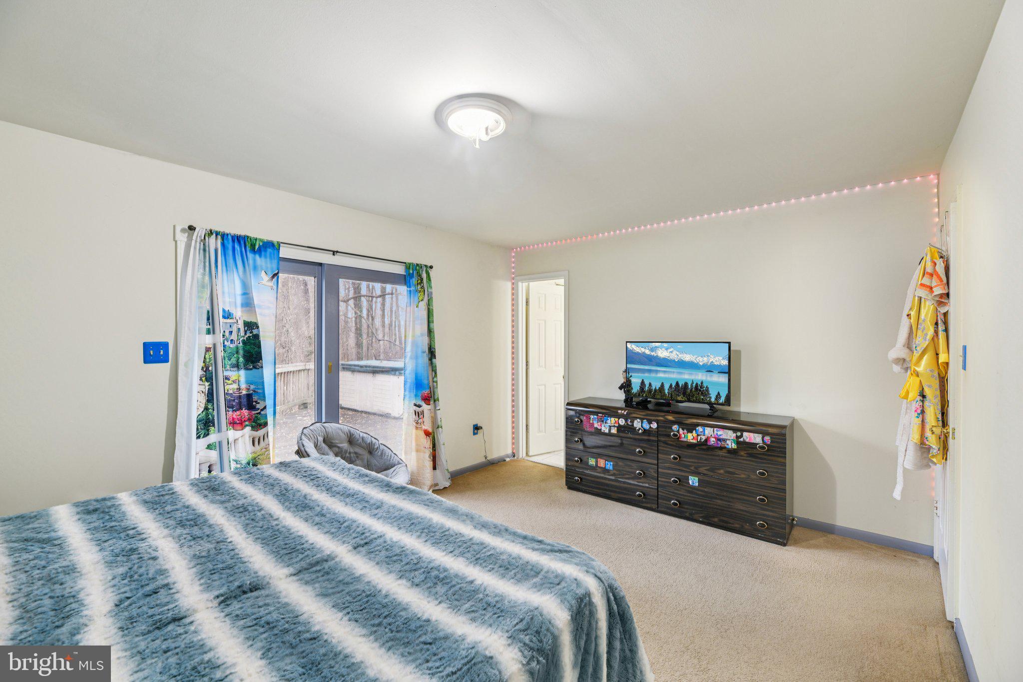 2650 Solomons Island Road Huntingtown, MD 20639 - Photo 24 of 44 a bedroom with a bed and a tv on the dresser