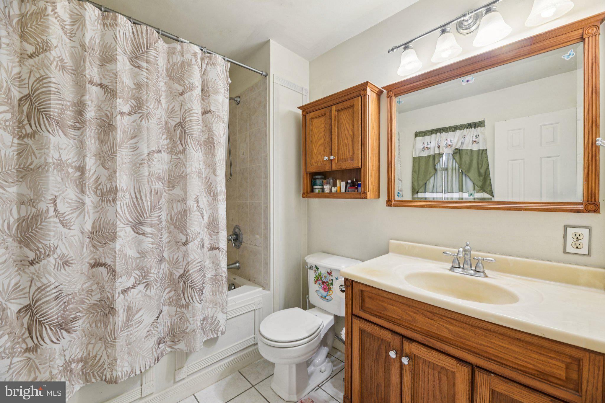 2650 Solomons Island Road Huntingtown, MD 20639 - Photo 26 of 44 a bathroom with a granite countertop sink toilet and a mirror