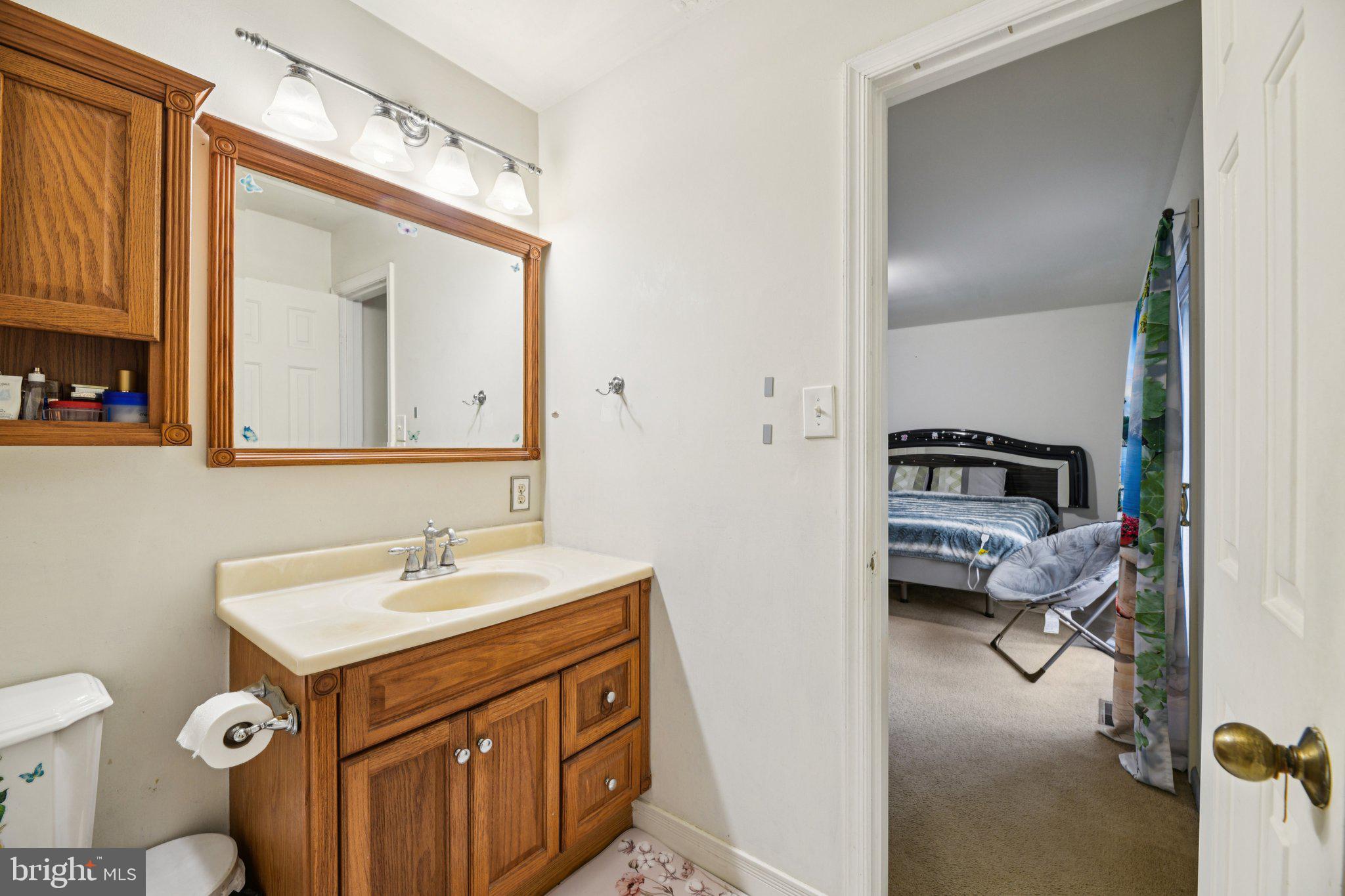 2650 Solomons Island Road Huntingtown, MD 20639 - Photo 27 of 44 a en suite bathroom with a sink and a mirror