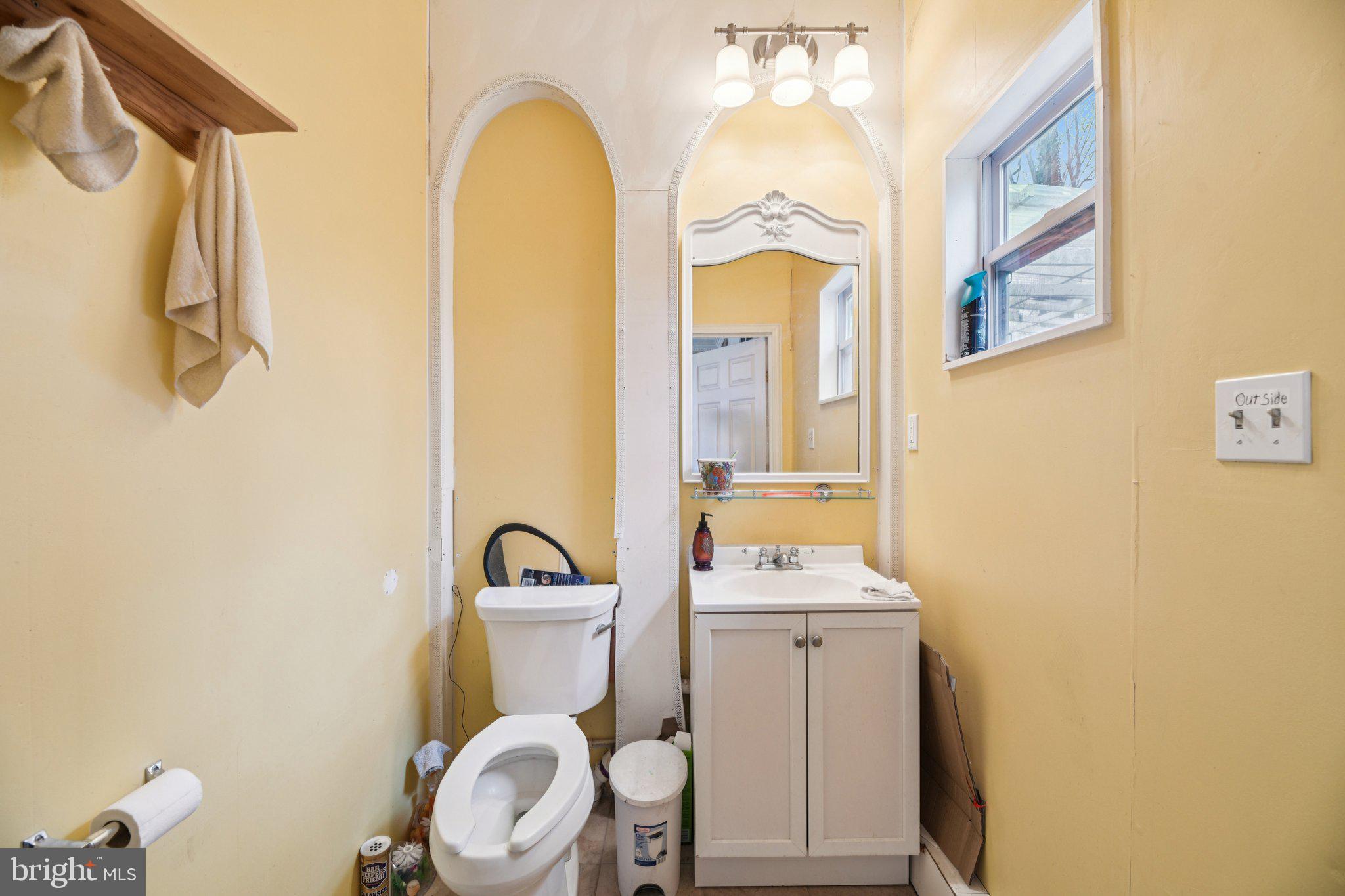 2650 Solomons Island Road Huntingtown, MD 20639 - Photo 28 of 44 a bathroom with a toilet sink and mirror