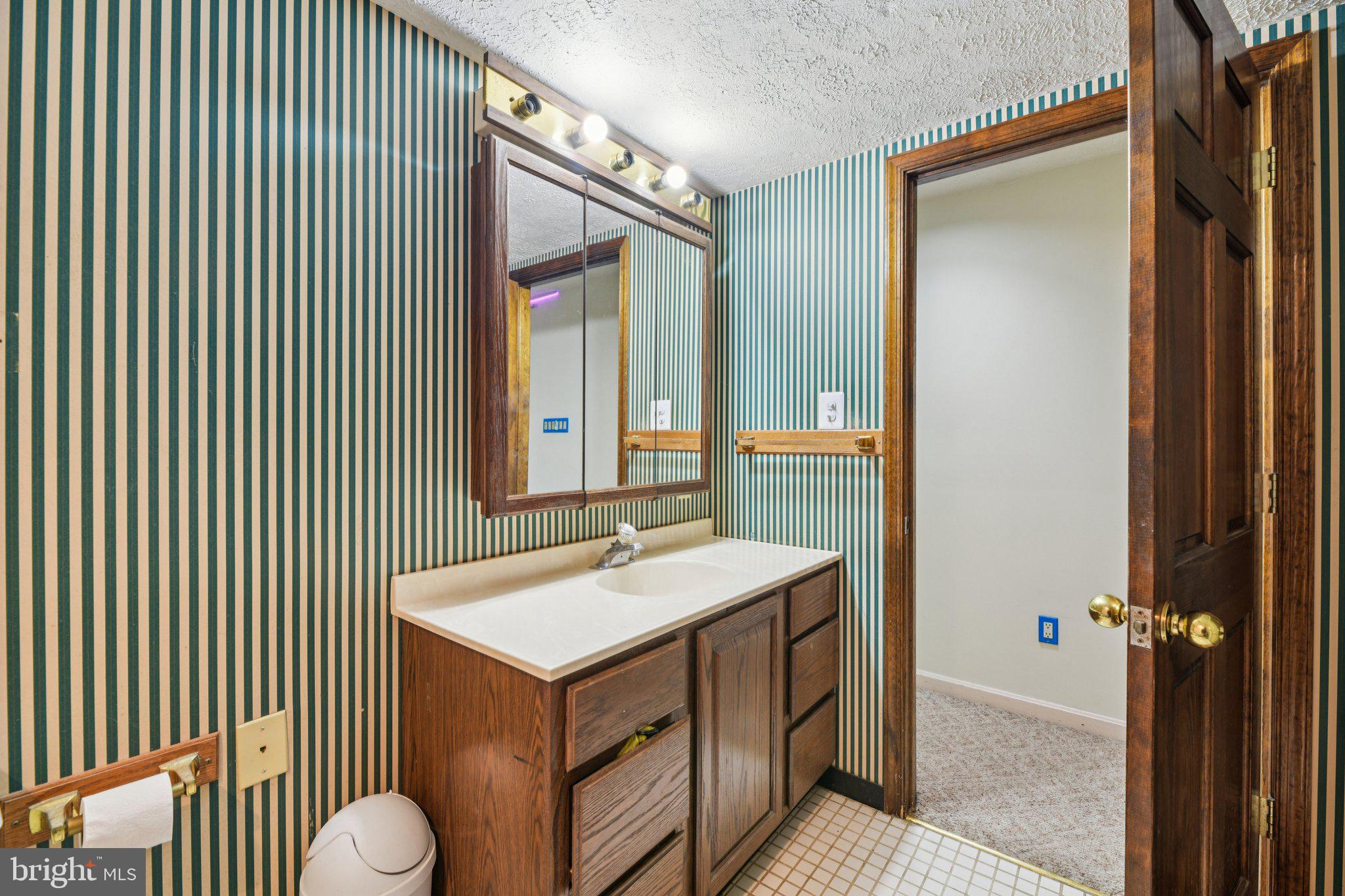 2650 Solomons Island Road Huntingtown, MD 20639 - Photo 29 of 44 a bathroom with a sink mirror and tub