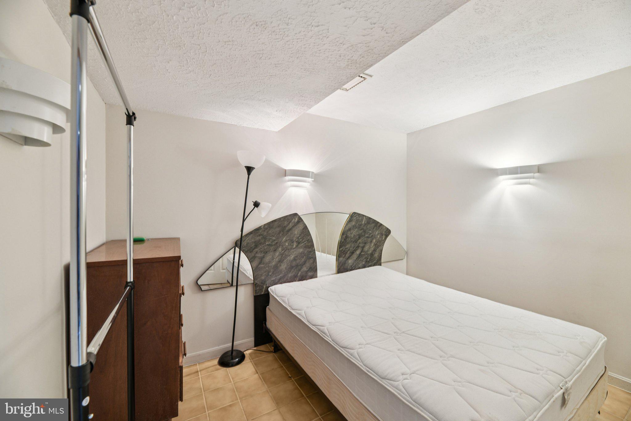 2650 Solomons Island Road Huntingtown, MD 20639 - Photo 37 of 44 a bed sitting in a room next to a window