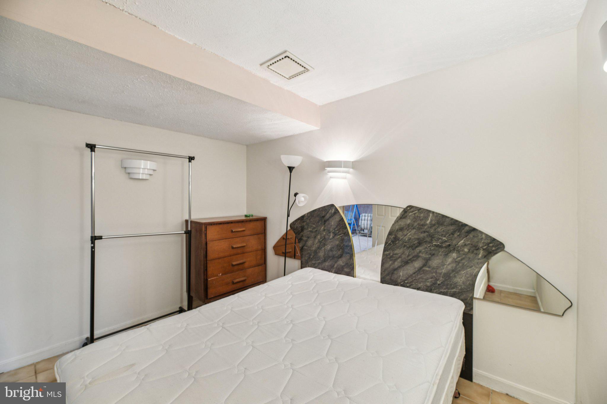 2650 Solomons Island Road Huntingtown, MD 20639 - Photo 38 of 44 a bedroom with a large bed and a closet