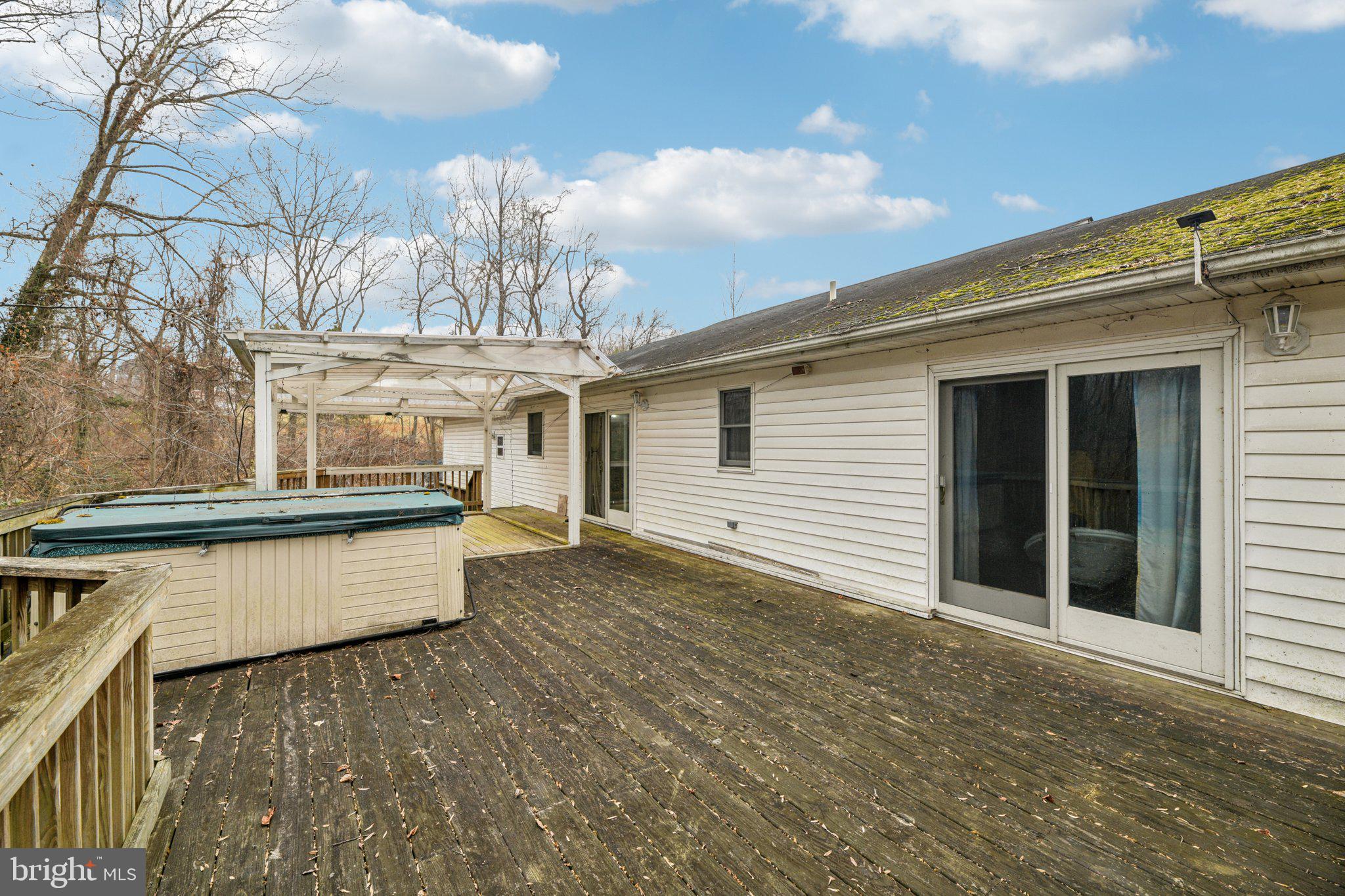 2650 Solomons Island Road Huntingtown, MD 20639 - Photo 8 of 44 a view of a white house with a large window and outdoor space