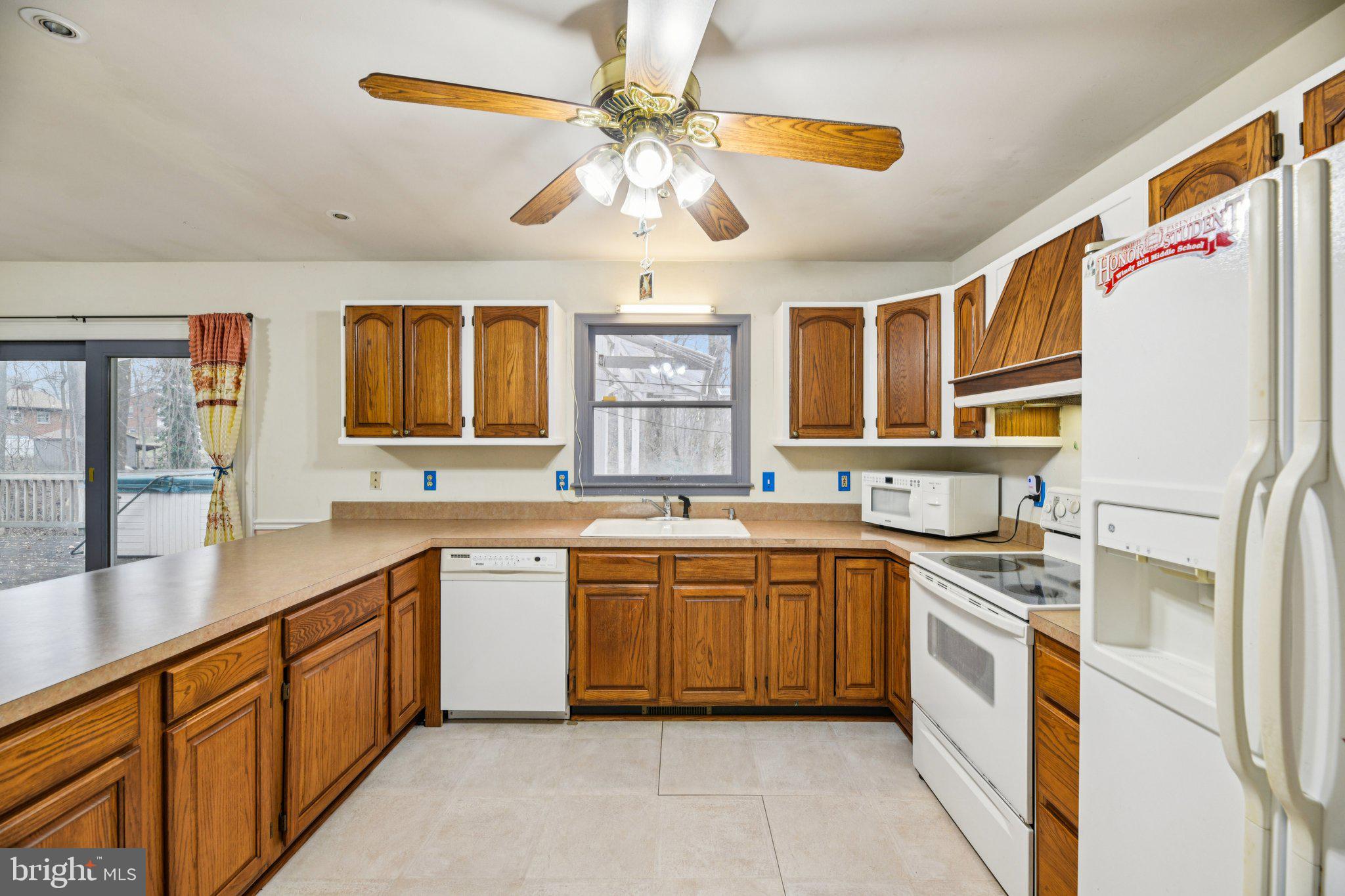 2650 Solomons Island Road Huntingtown, MD 20639 - Photo 10 of 44 a kitchen with stainless steel appliances granite countertop a sink and cabinets