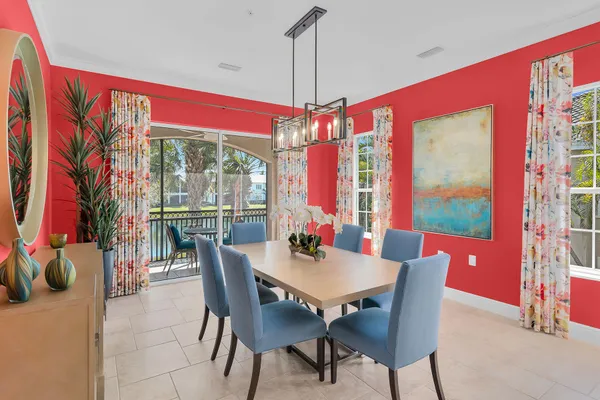 a view of a dining room with furniture large windows and wooden floor