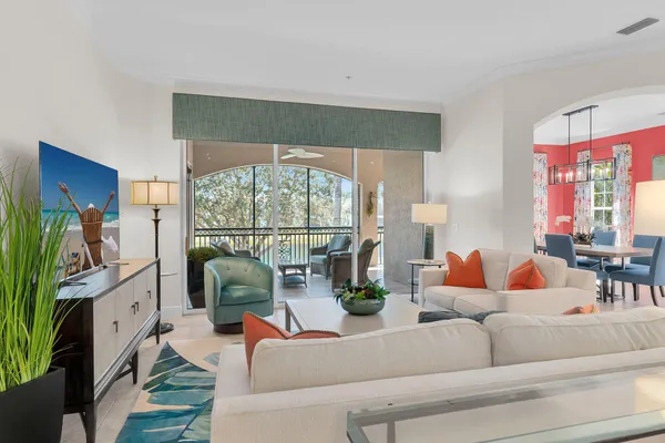 a living room with fireplace furniture and a floor to ceiling window
