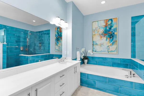 a bathroom with a sink a large mirror and a bathtub