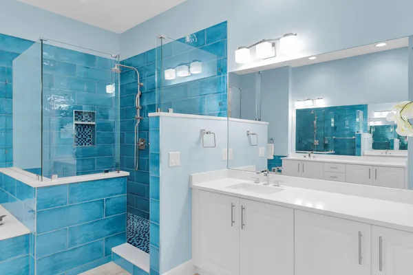 a bathroom with a shower sink and mirror