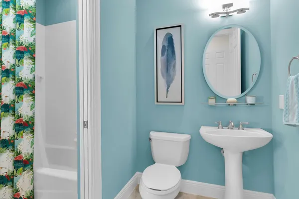 a bathroom with a sink toilet and a mirror