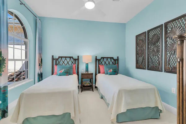 a bedroom with a bed table and a window